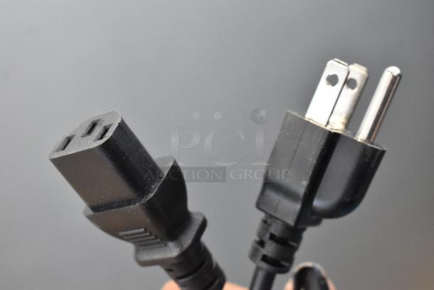A close-up of a black power cord with a plug suitable for Hobart HTi Metal Commercial Countertop Food Portioning Scale.