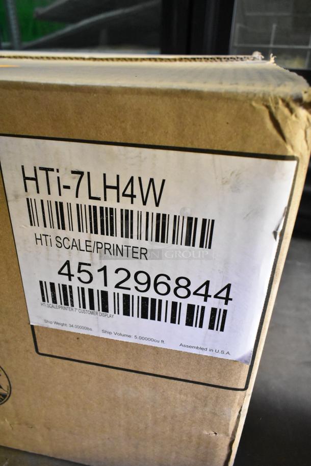 Brand new Hobart HTi metal countertop food portioning scale, 120/208-240V, 1 phase, in original box with minor scratches.