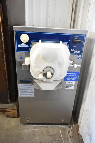 Carpigiani LB100/B stainless steel batch freezer. Commercial countertop model. 208/230 volts, 1 phase. Visible brand labels.
