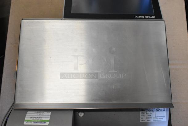 Mettler Toledo UCCW metal countertop food portioning scale, 100-240V, stainless steel surface, model details visible.