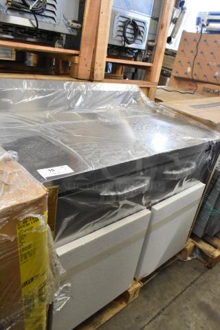 Brand new stainless steel commercial 2-door work top cooler in original packaging, minor scratches and dents visible.