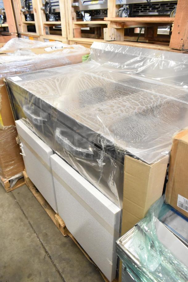 Brand new stainless steel 2-door worktop cooler, commercial grade, covered in protective wrapping, minor scratches.