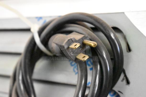 ALT TEXT: Close-up of electrical plug and cord for BKI 52473-1 stainless steel commercial meat freezer, 115 volts, 1 phase.