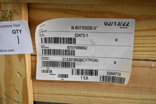 BRAND NEW BKI 2022 Stainless Steel Commercial Meat Freezer, Model 52473-1, in crate. Features casters, 115V, 1 Phase. Tags show model and serial numbers.