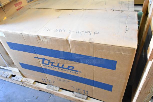 Brand new True TUC-48D-4-HCFSP stainless steel 4-drawer cooler in original box, 115 volts, 1 phase, on a pallet.