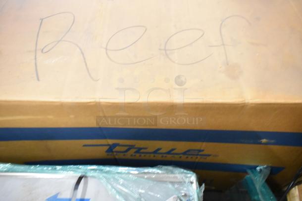 New True TUC-48D-4-HCFSP stainless steel commercial cooler in box, 4 drawers, 115V, 1 Phase, model labeling visible.