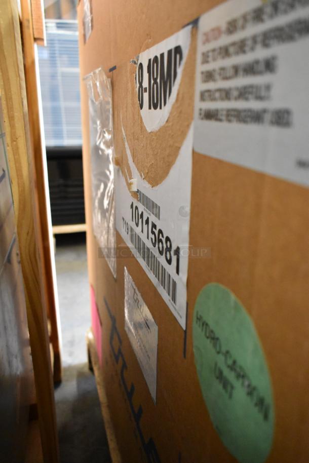 Brand new True TUC-48D-4-HCFSP stainless steel 4-drawer worktop cooler in box; model and handling labels visible.