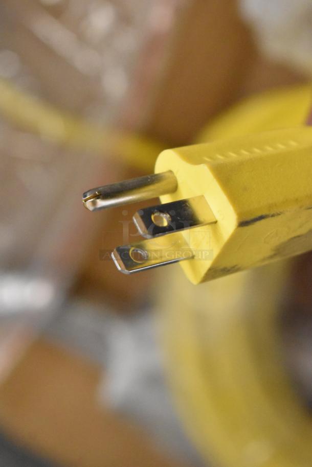 Close-up of the yellow power plug for a 2024 Lavex 978LAVP17A 17" rotary floor machine, showing minor scratches.