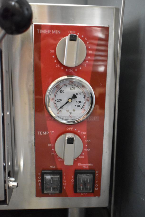 Front panel of Avantco 177DPO18S pizza oven with timer and temperature dials, switches for power and elements. Stainless steel finish.