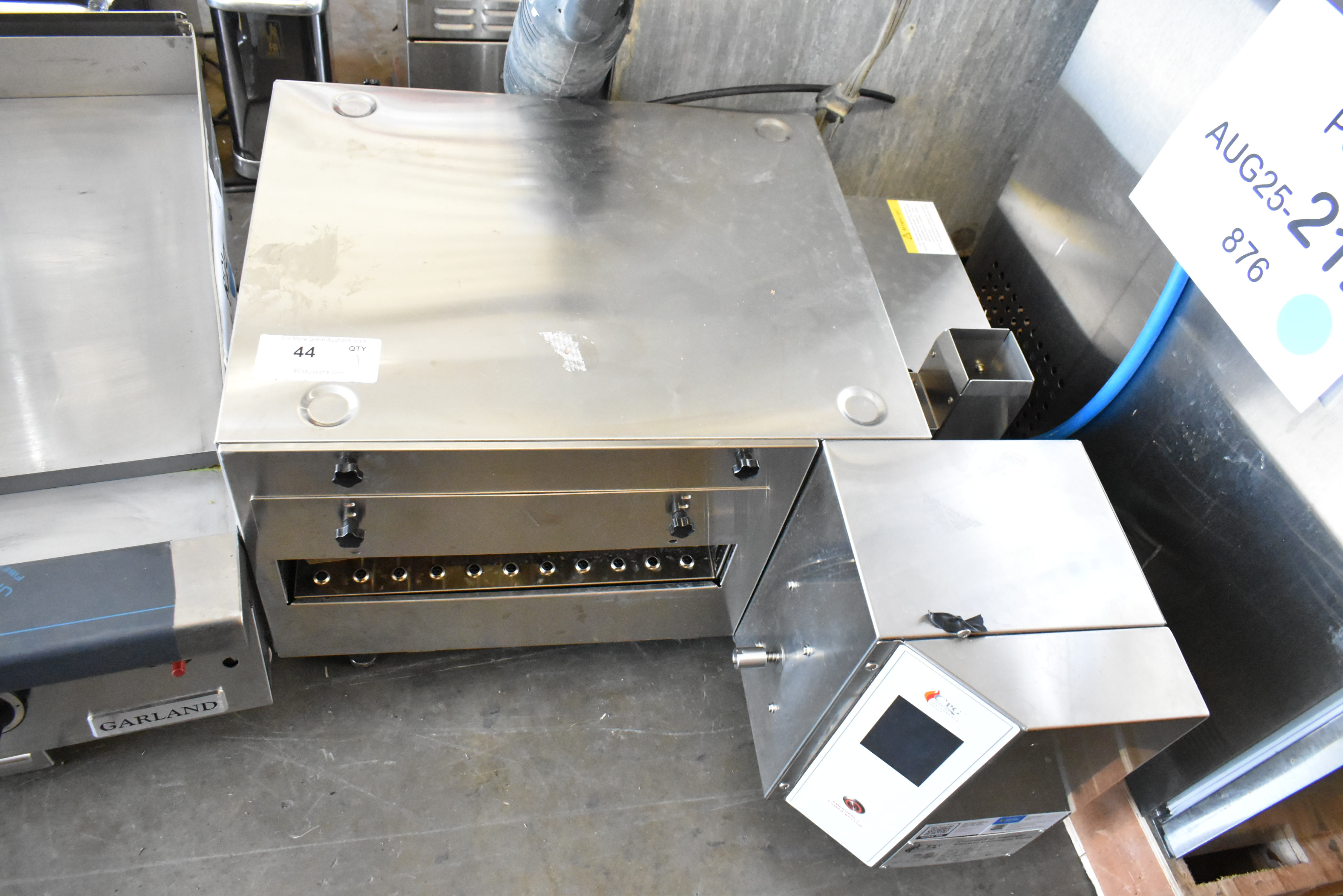 Conveyor pizza oven with belt removed showing interior cavity