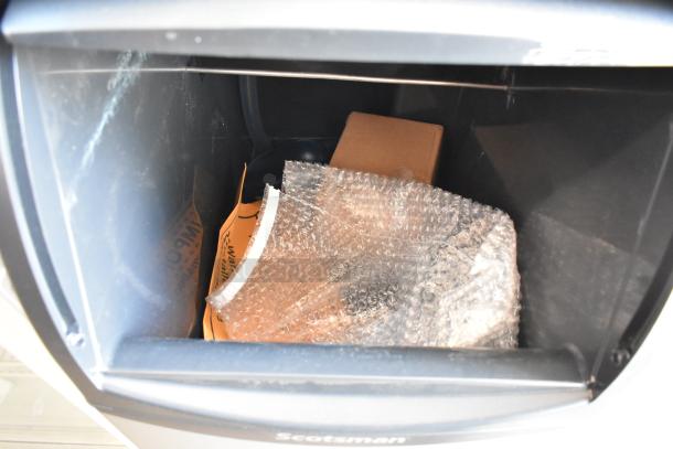 Brand new Scotsman CU0415MA-1A stainless steel ice machine interior; bubble-wrapped parts visible, slight scratches.