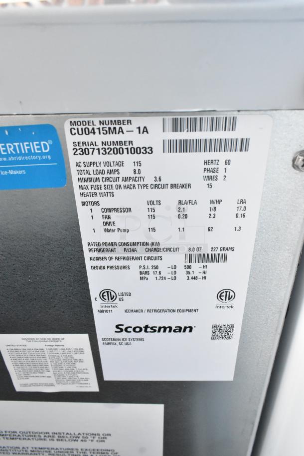 Brand new 2023 Scotsman CU0415MA-1A stainless steel undercounter ice machine. 58 lb. capacity, 115 volts, 1 phase. Label shows model and serial numbers, voltage, and certification details.