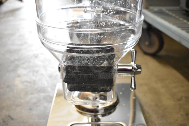 Brand new metal and poly dry dispenser with minor scratches and dents; features a clear hopper and metallic handle.