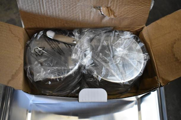 Brand new stainless steel chafer in original packaging, minor box damage, sealed in plastic, labeled with recycling symbol.