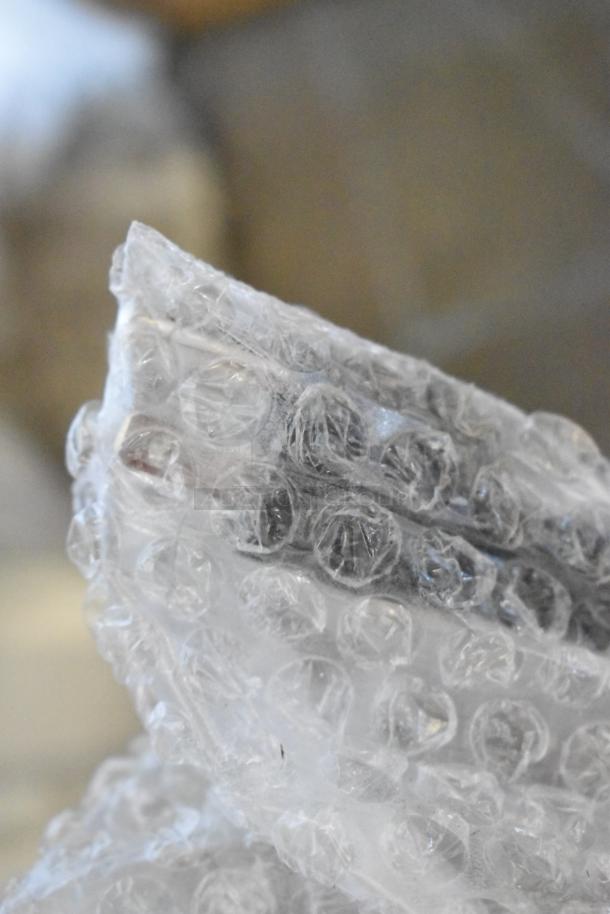 Bubble wrap packaging, potentially covering the 2025 Avantco 177F102 stainless steel dual tank electric countertop fryer.