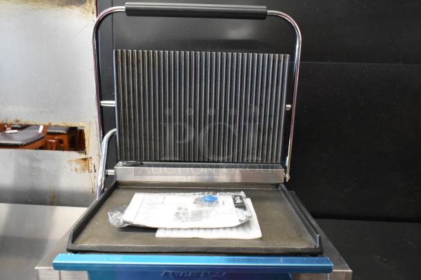 Brand new 2023 Avantco 177PG200GS Panini Grill with grooved top, smooth bottom, and 13 3/8" x 8 3/4" surface.