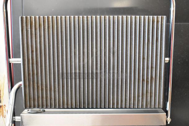 Brand new Avantco 177PG200GS Panini Grill with grooved top, smooth bottom, 13 3/8" x 8 3/4" surface, stainless steel.
