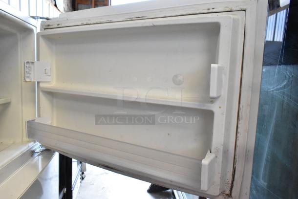 Whirlpool WRT511SZDW00 reach-in cooler with freezer, 115V, 1 phase, moderate wear, white interior door shelves visible.