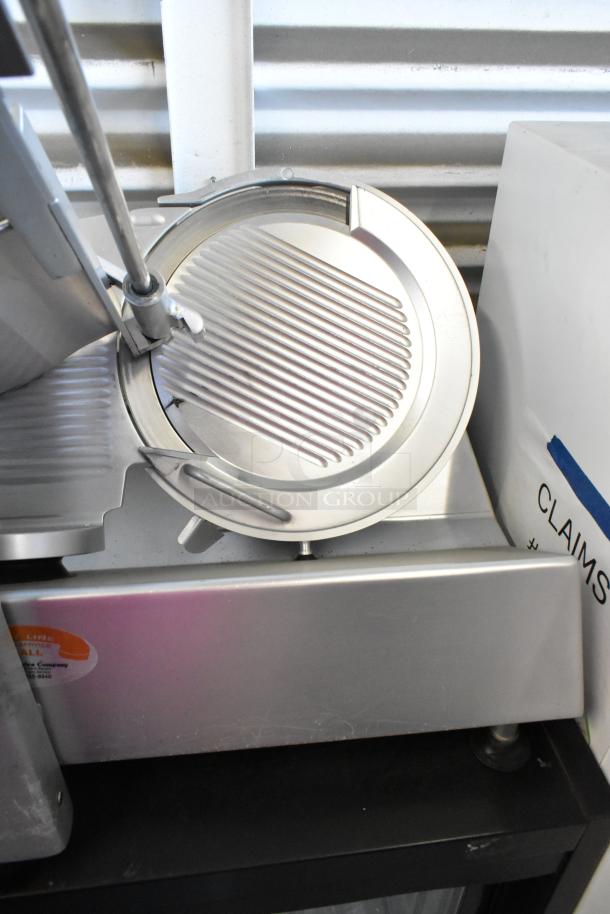 Bizerba stainless steel commercial meat slicer, countertop model, 115 volts, 1 phase, lightly used, visible service label.