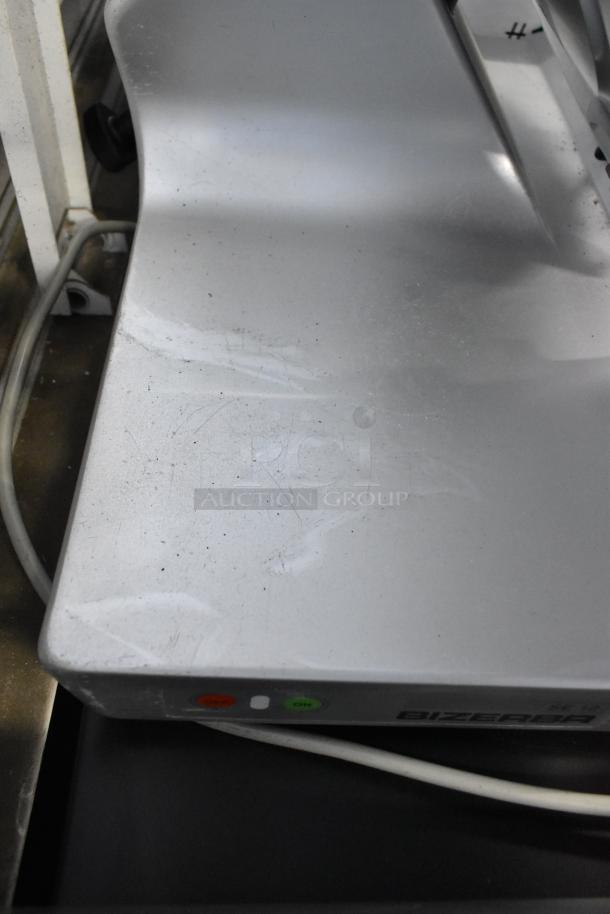 Bizerba stainless steel countertop meat slicer, 115 volts, 1 phase, visible wear on surface, brand label visible.
