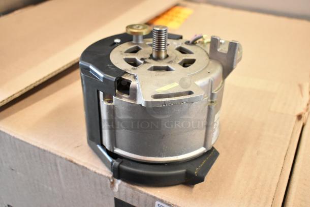 Bizerba SE 12 US stainless steel commercial meat slicer motor component, shown partially assembled, on cardboard box.