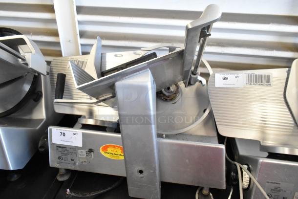 Bizerba SE 12 US stainless steel meat slicer, commercial countertop model, 115V, 1 phase, auction tags visible.