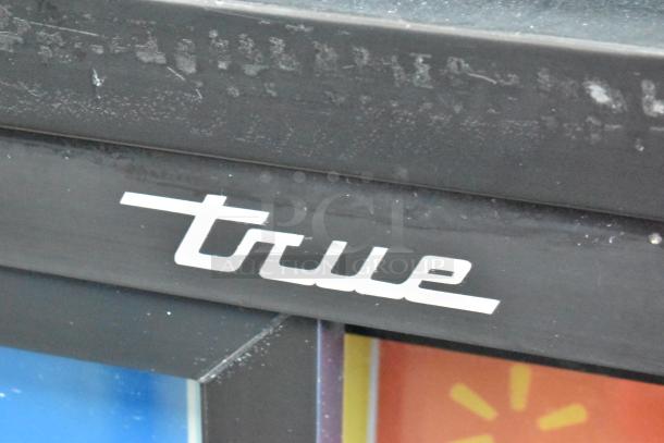 2017 True GDM-41SL-48-HC-LD commercial cooler with poly-coated racks. "True" logo visible on black metal surface.