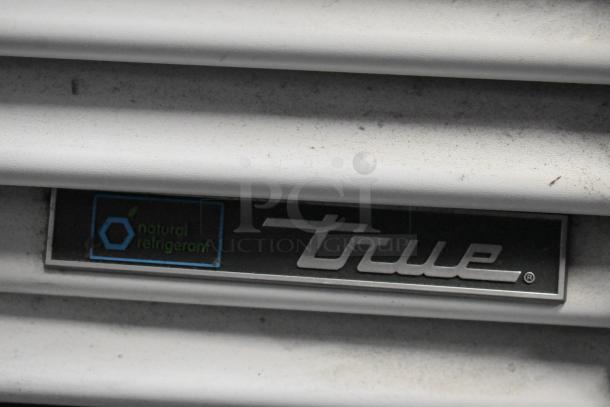 2021 True TSCI-600R-G-PH cooler with natural refrigerant label. Features metal body, glass door, poly coated racks, 115V, 1 phase.
