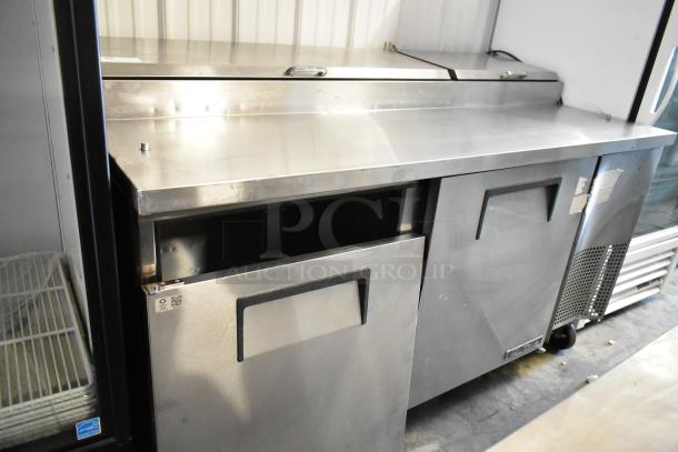 2017 True TPP-67 stainless steel commercial pizza prep table, 115 volts, on casters, with two doors and work surface.