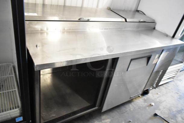 2017 True TPP-67 stainless steel commercial pizza prep table, with dual compartments and commercial casters, in good condition.