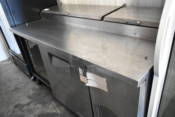 2017 True TPP-67 pizza prep table, stainless steel, commercial casters, 115V, 1 phase, visible wear marks, intact structure.