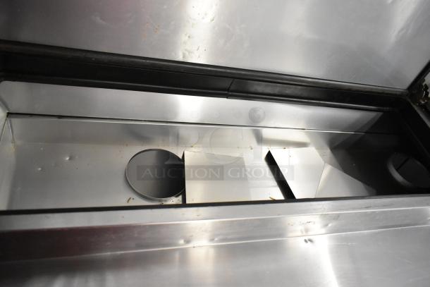 2017 True TPP-67 stainless steel pizza prep table, interior view, on commercial casters, 115 volts, 1 phase.