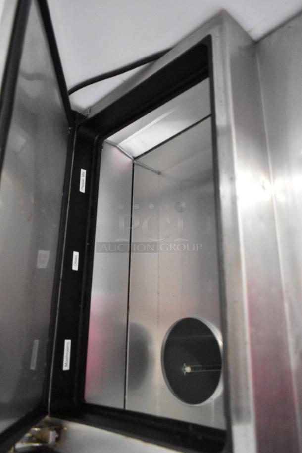 2017 True TPP-67 stainless steel pizza prep table interior view, showing commercial casters; 115 volts, 1 phase.