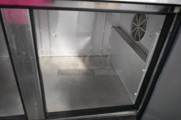 2017 True TPP-67 stainless steel pizza prep table, commercial casters, interior view, 115 volts, 1 phase.