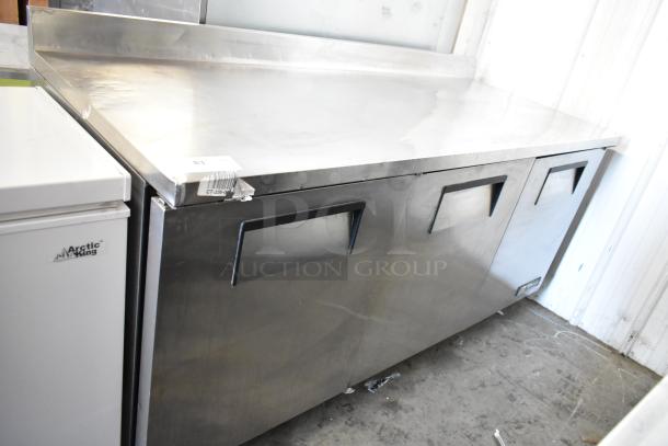 True TWT-72 stainless steel pizza prep table, commercial casters, 115V, 1 Phase, three-section doors, used condition.