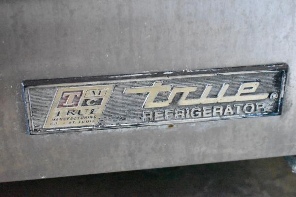 True TWT-72 stainless steel commercial pizza prep table, features label detailing True Manufacturing Co., St. Louis.