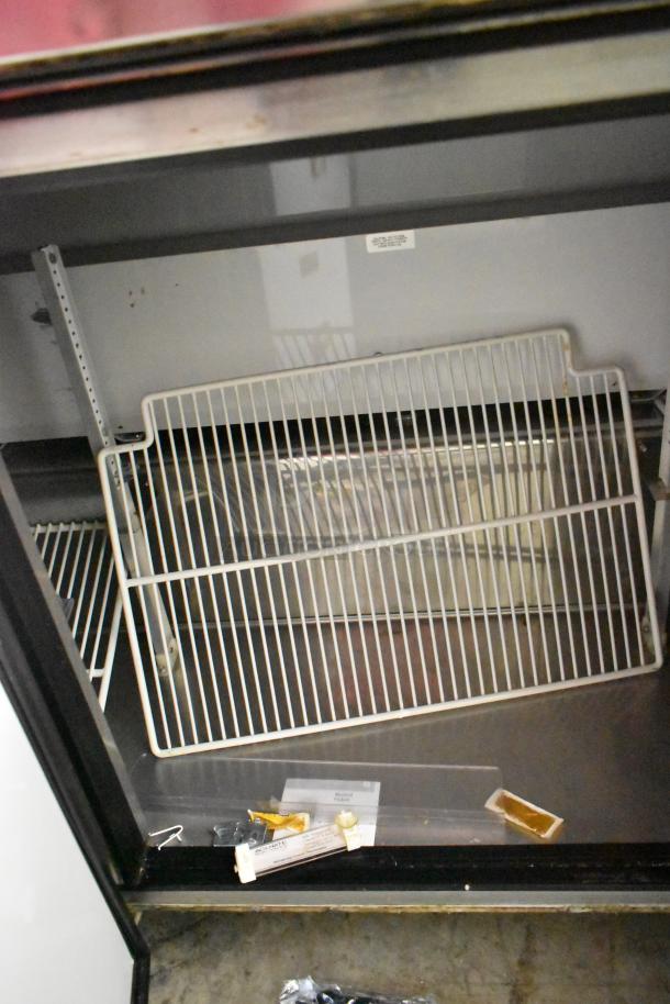 True TWT-72 Stainless Steel Commercial Pizza Prep Table with shelving, commercial casters, 115 Volts, 1 Phase. Appears clean.