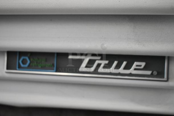 2021 True TSCI-600R-G-PH metal reach-in cooler merchandiser with poly coated racks, 115 volts, displaying logo.