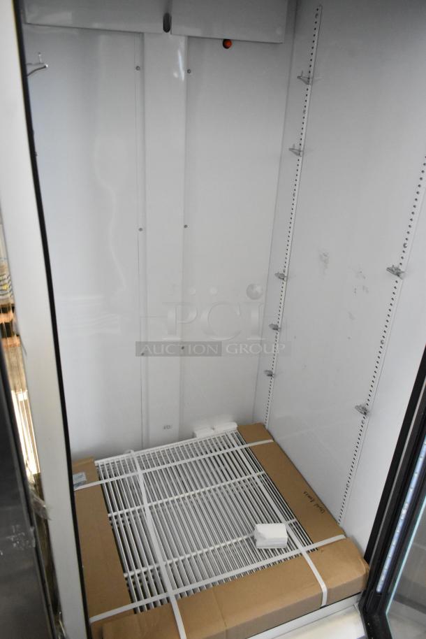 2021 True TSCI-600R-G-PH single door reach-in cooler, 115V, 1-phase, with poly coated racks and sleek metal finish.