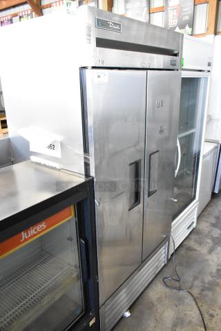 2017 True T-35-HC stainless steel commercial reach-in cooler with two doors and poly-coated racks, 115 volts, 1 phase.