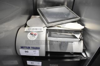 Mettler Toledo UCCW metal commercial countertop food portioning scale, 100-240V, with visible inspection sticker and barcode tag.