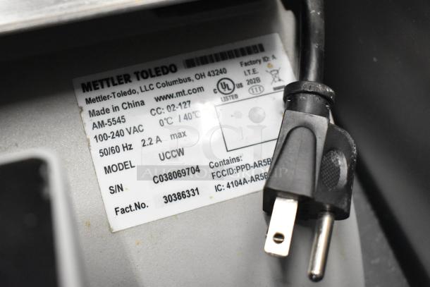 Mettler Toledo UCCW commercial countertop food portioning scale label, 100-240V, model and specs visible.