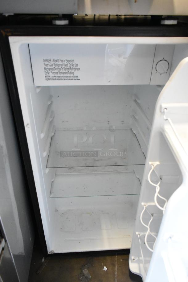 Galanz GLR33MBKE23 mini cooler, metal finish, 115 volts, single phase, interior shelves, visible label warnings.