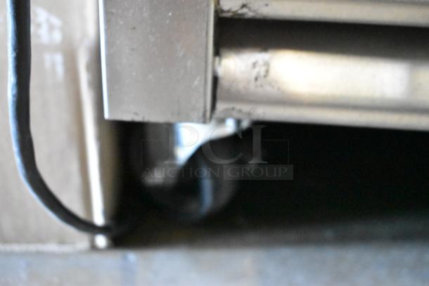 2016 True T-35 stainless steel commercial cooler corner, showing caster wheel and power cord. Model T-35.