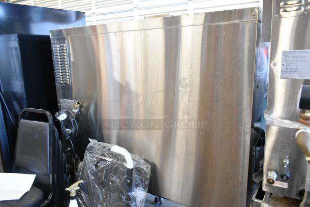 Hardt Inferno 3500 stainless steel commercial rotisserie oven. Natural gas-powered, 40-bird capacity, 76,000 BTU. Mounted on casters.