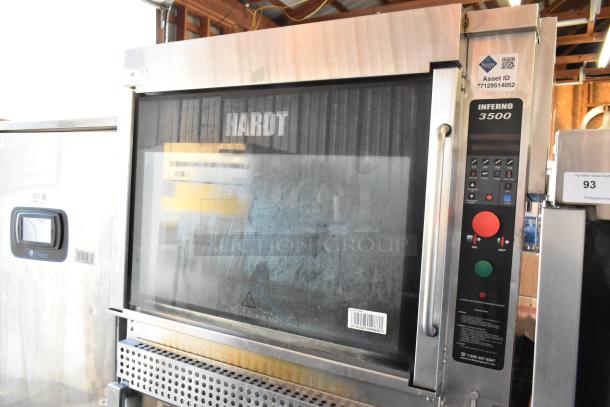 Hardt Inferno 3500 stainless steel commercial rotisserie oven, 40-bird capacity, 76,000 BTU, on casters, controls visible.