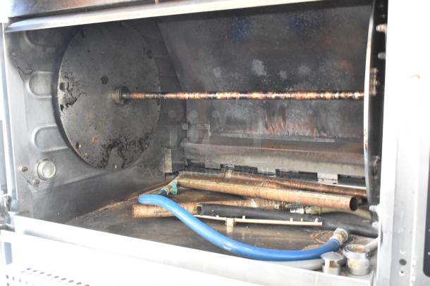 Hardt Inferno 3500 stainless steel rotisserie oven interior, showing rotisserie mechanism and gas connections.