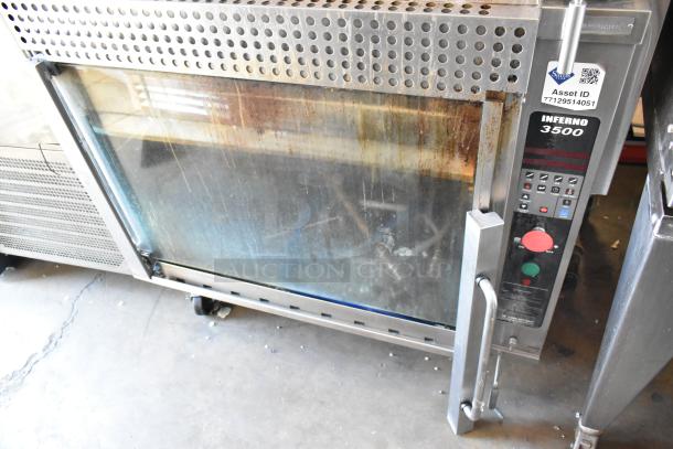 Hardt Inferno 3500 stainless steel rotisserie oven, 40 bird capacity, natural gas, commercial casters visible, model label shown.