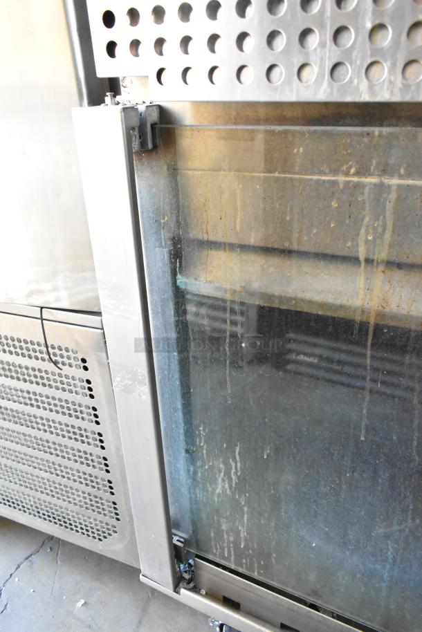 Hardt Inferno 3500 stainless steel rotisserie oven, natural gas, 40-bird capacity, on commercial casters, visible wear.