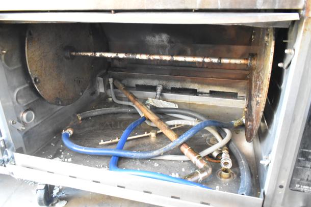 Two Hardt Inferno 3500 rotisserie ovens with 40-bird capacity, natural gas powered, on commercial casters. Interior view showing components.